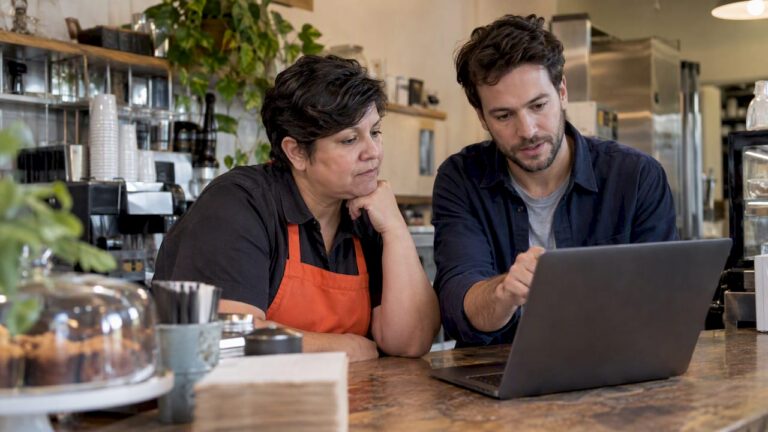 Franchise owner and coordinator reviewing campaigns